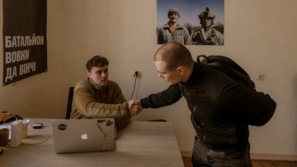 KYIV, UKRAINE - APRIL 10: Maksym, a former actor in charge of the recruiting center, talks to Dmytro Jasynok from Sumy who decided to voluntarily join the unit after a bomb fell 100 meters from his home, at Recruiting Center of Da Vinci Wolves Battalion from Ukrainian Army in Kyiv, Ukraine on April 10, 2024. After the president Zelenskyy signed new mobilization law in Ukraine, military conscription age is lowered from 27 to 25 in an effort to replenish its depleted ranks after more than two years of war. Andre Luis Alves / AnadoluNo Use USA No use UK No use Canada No use France No use Japan No use Italy No use Australia No use Spain No use Belgium No use Korea No use South Africa No use Hong Kong No use New Zealand No use Turkey