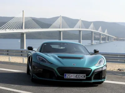 A Croatian made 'Nevera' electric car is parked near the newly built Peljesac Bridge in Komarna, southern Croatia, Tuesday, July 26, 2022. Croatia is marking the opening of a key and long-awaited bridge connecting two parts of the country's Adriatic Sea coastline while bypassing a small part of Bosnia's territory. (AP Photo)