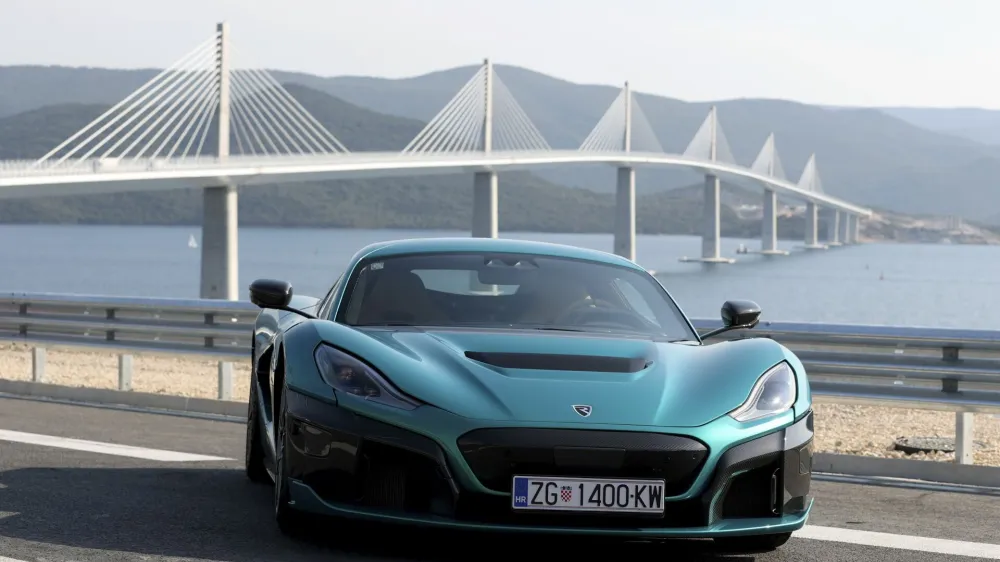 A Croatian made 'Nevera' electric car is parked near the newly built Peljesac Bridge in Komarna, southern Croatia, Tuesday, July 26, 2022. Croatia is marking the opening of a key and long-awaited bridge connecting two parts of the country's Adriatic Sea coastline while bypassing a small part of Bosnia's territory. (AP Photo)