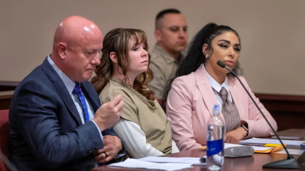 Hannah Gutierrez-Reed, the former armorer at the movie Rust, sits with her attorney Jason Bowles and paralegal Carmella Sisneros, during her sentencing hearing at First District Court, in Santa Fe, New Mexico, U.S., April 15, 2024. Eddie Moore/Pool via REUTERS