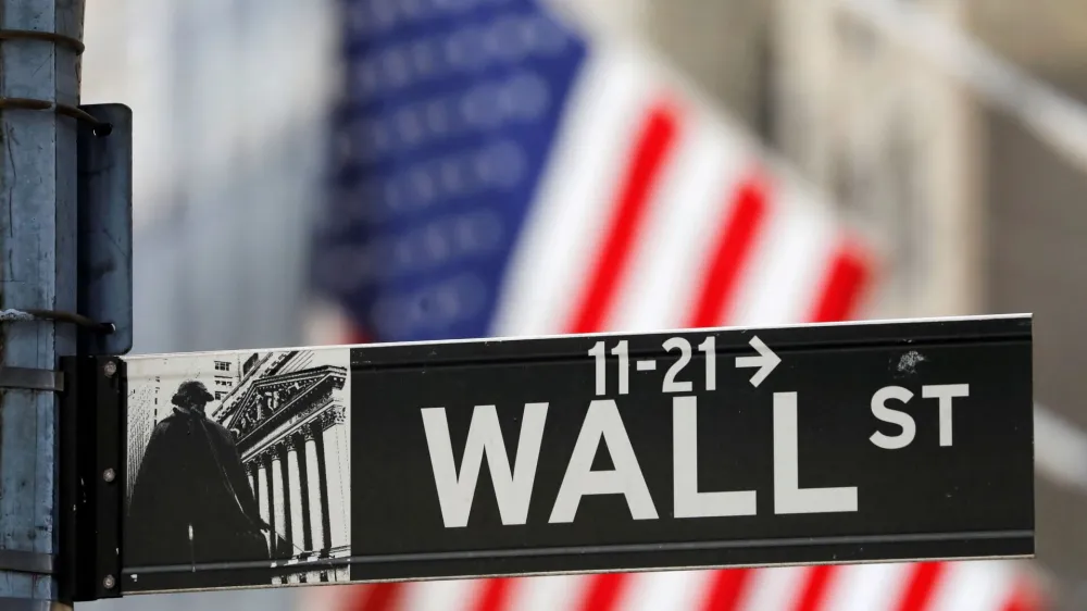 FILE PHOTO: A street sign for Wall Street is seen outside the New York Stock Exchange (NYSE) in New York City, New York, U.S., July 19, 2021. REUTERS/Andrew Kelly/File Photo