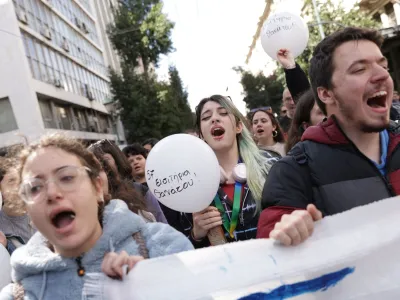 Protesters hold balloons during a demonstration, after a crash in which two trains collided near the Greek city of Larissa, in Athens, Greece, March 3, 2023. The ballon reads "57 death tickets". REUTERS/Louiza Vradi