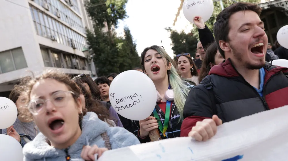Protesters hold balloons during a demonstration, after a crash in which two trains collided near the Greek city of Larissa, in Athens, Greece, March 3, 2023. The ballon reads "57 death tickets". REUTERS/Louiza Vradi