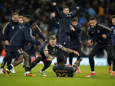 Real Madrid players celebrate after wining the Champions League quarterfinal second leg soccer match between Manchester City and Real Madrid at the Etihad Stadium in Manchester, England, Wednesday, April 17, 2024. (AP Photo/Dave Thompson)