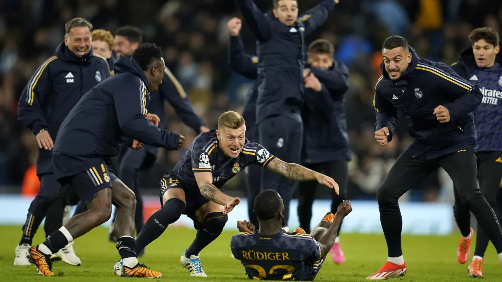 Real Madrid players celebrate after wining the Champions League quarterfinal second leg soccer match between Manchester City and Real Madrid at the Etihad Stadium in Manchester, England, Wednesday, April 17, 2024. (AP Photo/Dave Thompson)