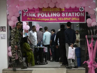 People wait in a queue at a Pink Polling Station, where all the polling officials are women, to cast their vote during the first round of polling of India's national election in Udhampur, Jammu and Kashmir, India, Friday, April 19, 2024. Nearly 970 million voters will elect 543 members for the lower house of Parliament for five years, during staggered elections that will run until June 1. (AP Photo/Channi Anand)
