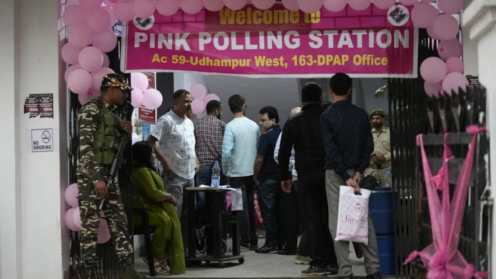 People wait in a queue at a Pink Polling Station, where all the polling officials are women, to cast their vote during the first round of polling of India's national election in Udhampur, Jammu and Kashmir, India, Friday, April 19, 2024. Nearly 970 million voters will elect 543 members for the lower house of Parliament for five years, during staggered elections that will run until June 1. (AP Photo/Channi Anand)