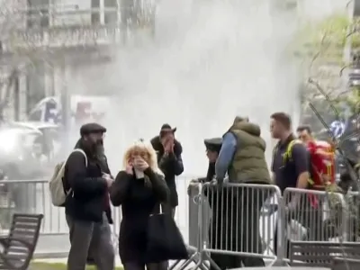 In this image taken from video, bystanders react after witnessing a man who lit himself on fire was extinguished, Friday, April 19, 2024, in a park outside Manhattan criminal court in New York. Emergency crews rushed away a person on a stretcher after the fire was extinguished outside the courthouse where jury selection was taking place in former President Donald Trump's hush money criminal case. (AP Photo)