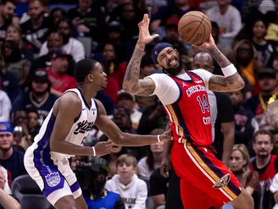 Apr 19, 2024; New Orleans, Louisiana, USA; New Orleans Pelicans forward Brandon Ingram (14) dribbles against Sacramento Kings guard De'Aaron Fox (5) in the second half during a play-in game of the 2024 NBA playoffs at Smoothie King Center. Mandatory Credit: Stephen Lew-USA TODAY Sports
