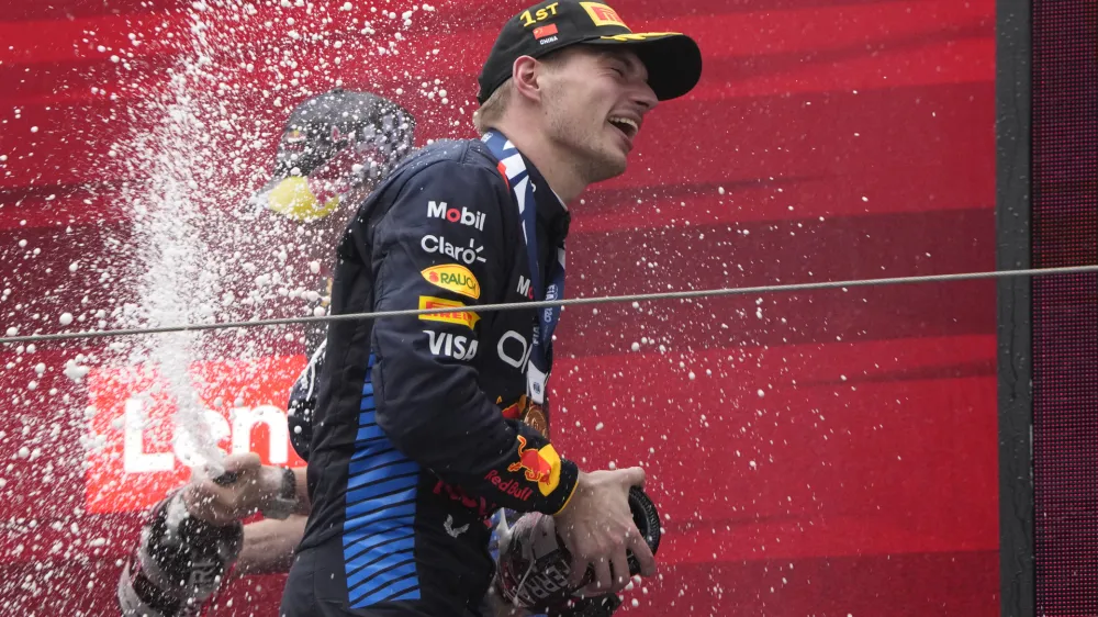 Red Bull driver Max Verstappen of the Netherlands celebrates on the podium after winning the Chinese Formula One Grand Prix at the Shanghai International Circuit, Shanghai, China, Sunday, April 21, 2024. (AP Photo/Andy Wong)