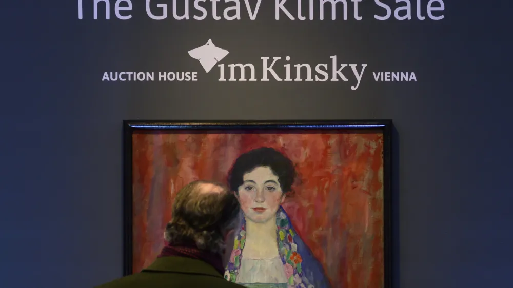 A man looks at the painting 'Portrait of Fräulein Lieser' by Austrian painter Gustav Klimt prior to an auction, in Vienna, Wednesday, April 24, 2024. A portrait of a young woman by Gustav Klimt that was long believed to be lost has been sold at an auction in Vienna for 30 million euros ($32 million). The Austrian modernist artist started work on the "Portrait of Fräulein Lieser" in 1917, the year before he died, and it is one of his last works. (AP Photo/Christian Bruna)