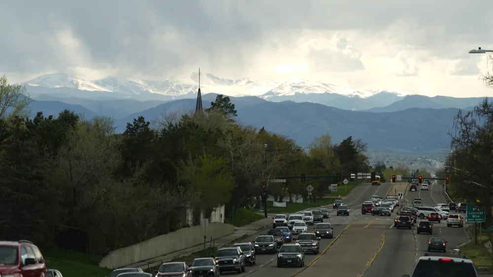 Rain clouds roll off the Rocky Mountains as motorists slog through evening rush hour traffic eastbound on Hampden Avenue Friday, April 26, 2024, in southeast Denver. Forecasters are predicting that a spring storm will dump rain along the Front Range and snow in some mountain locations before moving on to the Great Plains. (AP Photo/David Zalubowski)