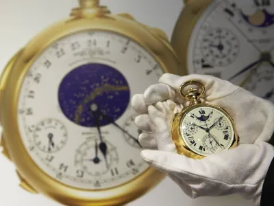 A staff member holds "The Henry Graves Supercomplication" handmade watch by Patek Philippe at Sotheby's auction house in Geneva in this November 5, 2014 file photo. A gold pocket watch made by Patek Philippe for a New York banker in the early 1930s fetched 23.2 million Swiss francs ( million) at auction on Tuesday, smashing the record for a timepiece it set 15 years ago, Sotheby's said. Henry Graves commissioned the famed Swiss watchmaker to produce the world's most complicated watch and surpass one made for James Packard, the American automobile manufacturer. Picture taken November 5, 2014.REUTERS/Denis Balibouse/Files (SWITZERLAND - Tags: SOCIETY BUSINESS)