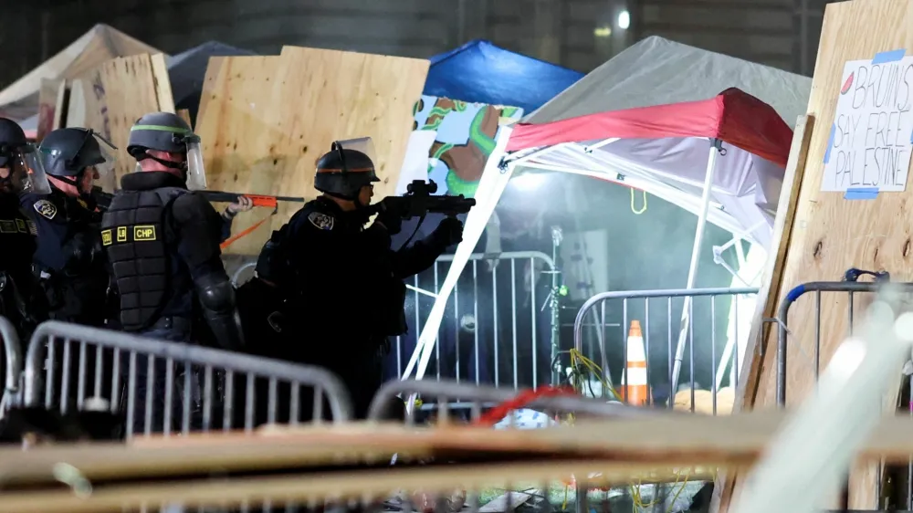 Law enforcement officers stand as protesters supporting Palestinians in Gaza gather at an encampment at the University of California Los Angeles (UCLA), amid the conflict between Israel and the Palestinian Islamist group Hamas, in Los Angeles, California, U.S., May 2, 2024. REUTERS/Mike Blake