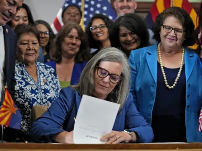Arizona Gov. Katie Hobbs, D, signs the repeal of the Civil War-era near-total abortion ban, Thursday, May 2, 2024, at the Capitol in Phoenix. Democrats secured enough votes in the Arizona Senate to repeal the ban on abortions that the state's highest court recently allowed to take effect. (AP Photo/Matt York)