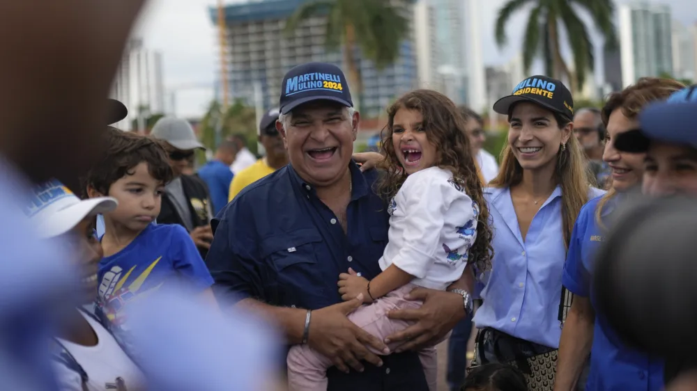 FILE - Presidential candidate Jose Raul Mulino holds his granddaughter Sofia accompanied by his daughter Monique, Sofia's mother, during a campaign event, in Panama City, April 26, 2024. Mulino replaced former president Ricardo Martinelli as the candidate for the Achieving Goals party. Martinelli was barred from running in March, because the ex-president was sentenced to more than 10 years in prison for money laundering.&nbsp; (AP Photo/Matias Delacroix, File)