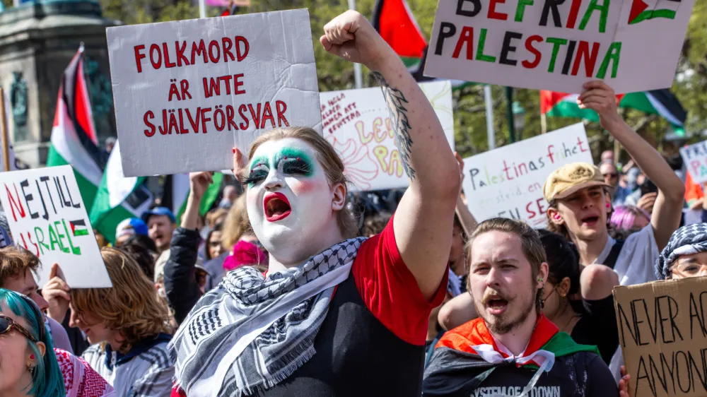 11 May 2024, Sweden, Malmo: Protesters hold placards and shout slogans during a Pro-Palestine rally before the final of the Eurovision Song Contest (ESC) 2024. Photo: Jens Büttner/dpa