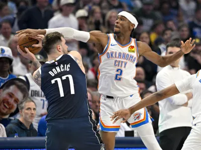 May 13, 2024; Dallas, Texas, USA; Oklahoma City Thunder guard Shai Gilgeous-Alexander (2) blocks a pass by Dallas Mavericks guard Luka Doncic (77) during the first quarter in game four of the second round for the 2024 NBA playoffs at American Airlines Center. Mandatory Credit: Jerome Miron-USA TODAY Sports