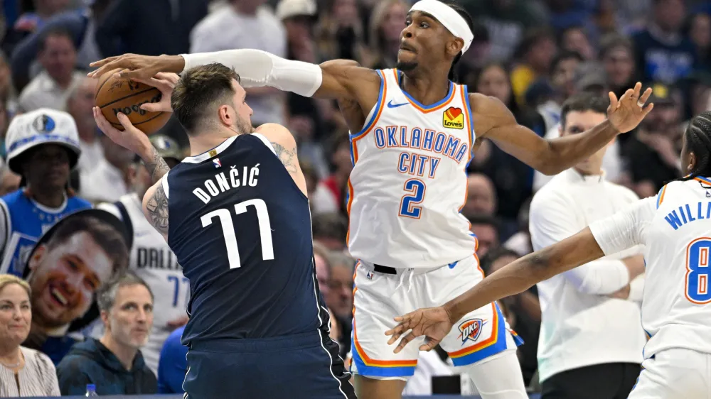 May 13, 2024; Dallas, Texas, USA; Oklahoma City Thunder guard Shai Gilgeous-Alexander (2) blocks a pass by Dallas Mavericks guard Luka Doncic (77) during the first quarter in game four of the second round for the 2024 NBA playoffs at American Airlines Center. Mandatory Credit: Jerome Miron-USA TODAY Sports