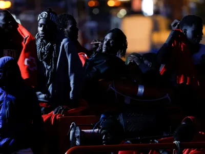 Migrants wait to disembark from a Spanish coast guard vessel, in the port of Arguineguin, on the island of Gran Canaria, Spain, May 13, 2024. REUTERS/Borja Suarez