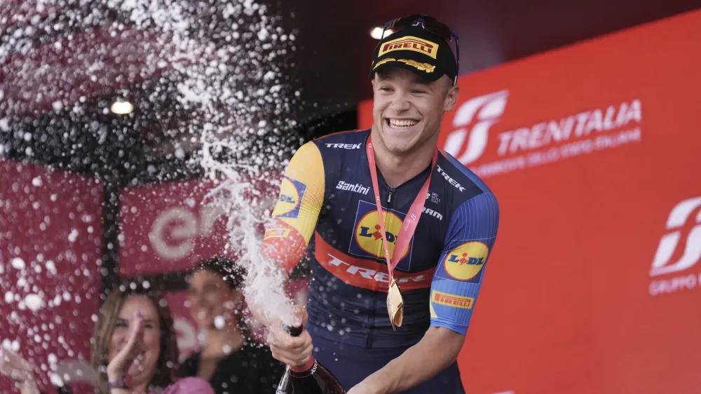 Italy's Jonathan Milan celebrates on podium after winning the 11th stage of the Giro d'Italia, Tour of Italy cycling race, from Foiano di Val Fortore to Francavilla al Mare, Italy, Wednesday, May 15, 2024. (Massimo Paolone/LaPresse via AP)