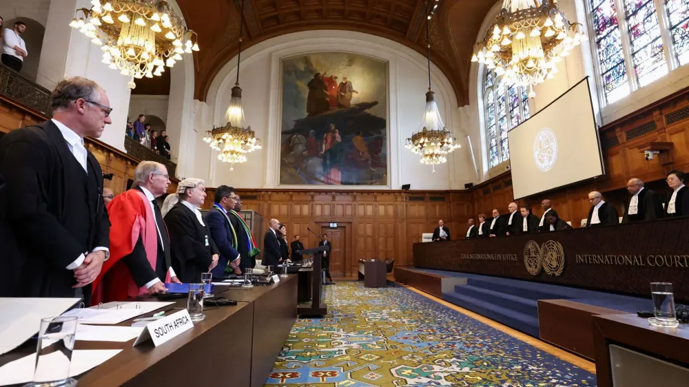 South African and Israeli delegations stand in front of judges at the International Court of Justice (ICJ), at the start of a hearing where South Africa requests new emergency measures over Israel's attacks on Rafah, as part of an ongoing case South Africa filed at the ICJ in December last year accusing Israel of violating the Genocide Convention during its offensive against Palestinians in Gaza, in The Hague Netherlands May 16, 2024. REUTERS/Yves Herman