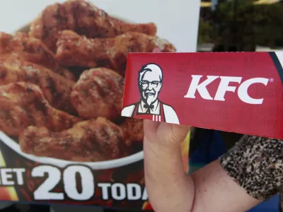 ﻿A customer holds a box of Kentucky Fried Chicken outside an KFC restaurant, Tuesday, July 13, 2010, in Mountain View, Calif. (AP Photo/Paul Sakuma)