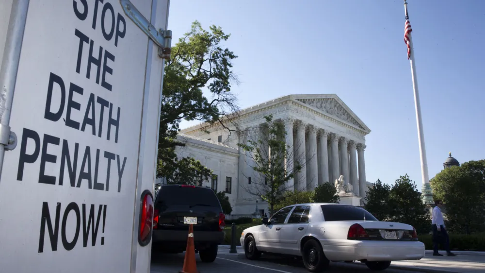 A vehicle parked near the Supreme Court in Washington, has signage that says "Stop The Death Penalty Now," Monday June 29, 2015. The Supreme Court is meeting for the final time until the fall to decide three remaining cases and add some new ones for the term that starts in October. The three remaining cases that are expected to be decided Monday raise important questions about a controversial drug that was implicated in botched executions, state efforts to reduce partisan influence in congressional redistricting and costly Environmental Protection Agency limits on the emission of mercury and other toxic pollutants from power plants. (AP Photo/Jacquelyn Martin)