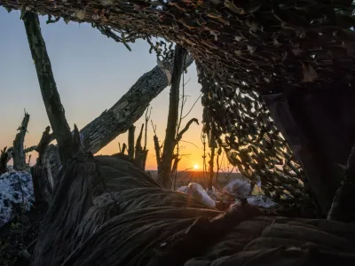 The sun rises over the battlefield near a frontline trench in the Donetsk region, amid Russia's attack on Ukraine, April 13, 2024. To match Special Report UKRAINE-WAR/FRONTLINE  REUTERS/Thomas Peter