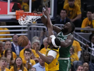 Boston Celtics guard Jaylen Brown, right, dunks the ball over Indiana Pacers center Myles Turner during the second half of Game 3 of the NBA Eastern Conference basketball finals, Saturday, May 25, 2024, in Indianapolis. (AP Photo/Darron Cummings)