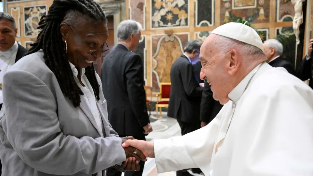 Pope Francis greets Whoopi Goldberg as he meets with comedians during a cultural event at the Vatican, June 14, 2024. Vatican Media/­Handout via REUTERS  ATTENTION EDITORS - THIS IMAGE WAS PROVIDED BY A THIRD PARTY. BEST QUALITY AVAILABLE.