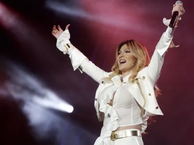 FILE - This June 17, 2006 file photo shows Svetlana Raznatovic, alias Ceca, a Serbian folk music icon and widow of Serbia's late warlord Zeljko Raznatovic-Arkan performing during her concert in Belgrade, Serbia. State prosecutors say they have charged Serbian folk music star Svetlana Raznatovic with embezzling about  million (Euro 4 million) from the sale of players from her late husband's football club to foreign teams. (AP Photo/Srdjan Ilic, File)