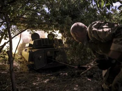 In this photo provided by Ukraine's 24th Mechanised Brigade press service, a soldier fires a "Gvozdika" 120mm Soviet-made howitzer towards Russian positions at outskirts of Chasiv Yar, Donetsk region, Ukraine, Saturday, June 22, 2024, (Oleg Petrasiuk/Ukraine's 24th Mechanised Brigade via AP)
