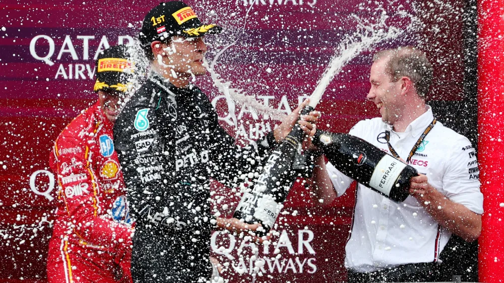 Formula One F1 - Austrian Grand Prix - Red Bull Ring, Spielberg, Austria - June 30, 2024 Mercedes' George Russell celebrates on the podium after winning the Austrian Grand Prix REUTERS/Florion Goga