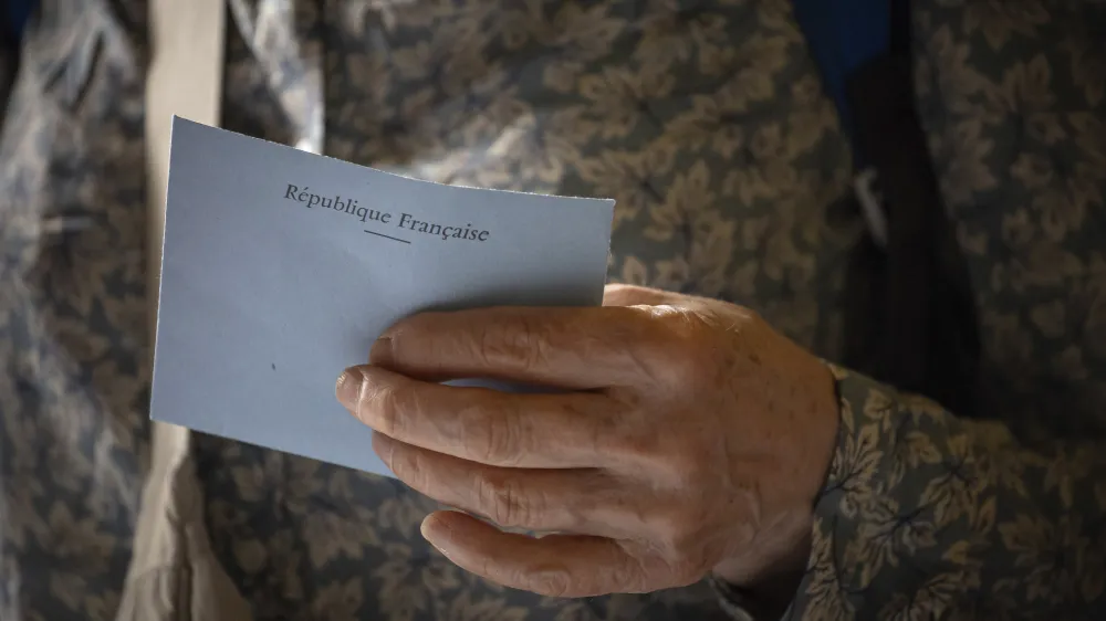 A voter casts a ballot at a polling station for the first round of the parliamentary elections in Paris, Sunday, June 30, 2024. (AP Photo/Aurelien Morissard)