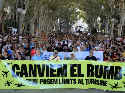 21 July 2024, Spain, Palma de Mallorca: People take part in a demonstration called by the organization "Less Tourism, More Life" against mass tourism on Mallorca. Photo: Clara Margais/dpa