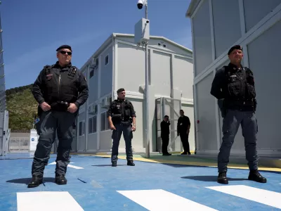 Italian police officers stand inside the reception camp at the port where Italy will process migrants, as Italy's Prime Minister Giorgia Meloni visits the sites, in Shengjin, Albania June 5, 2024. REUTERS/Florion Goga