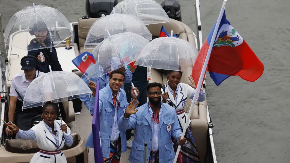 Paris 2024 Olympics - Opening Ceremony - Paris, France - July 26, 2024. Athletes of Haiti aboard a boat in the floating parade on the river Seine during the opening ceremony. REUTERS/Albert Gea