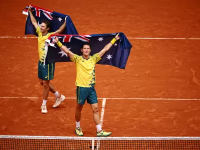 03 August 2024, France, Paris: Australia's tennis players John Peers and Matthew Ebden holding Australian flags, celebrate beating USA's Austin Krajicek and Rajeev Ram during their men's doubles final tennis match on Court Philippe-Chatrier at the Roland-Garros Stadium during the Paris 2024 Olympic Games. Photo: Dan Himbrechts/AAP/dpa