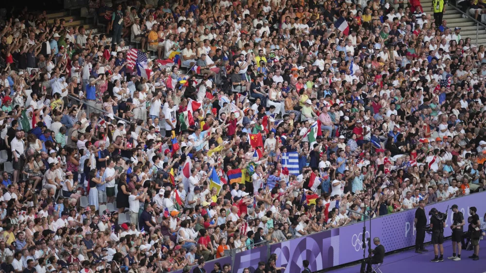 Spectators watch the 2024 Summer Olympics closing ceremony at the Stade de France, Sunday, Aug. 11, 2024, in Saint-Denis, France. (AP Photo/Kin Cheung)