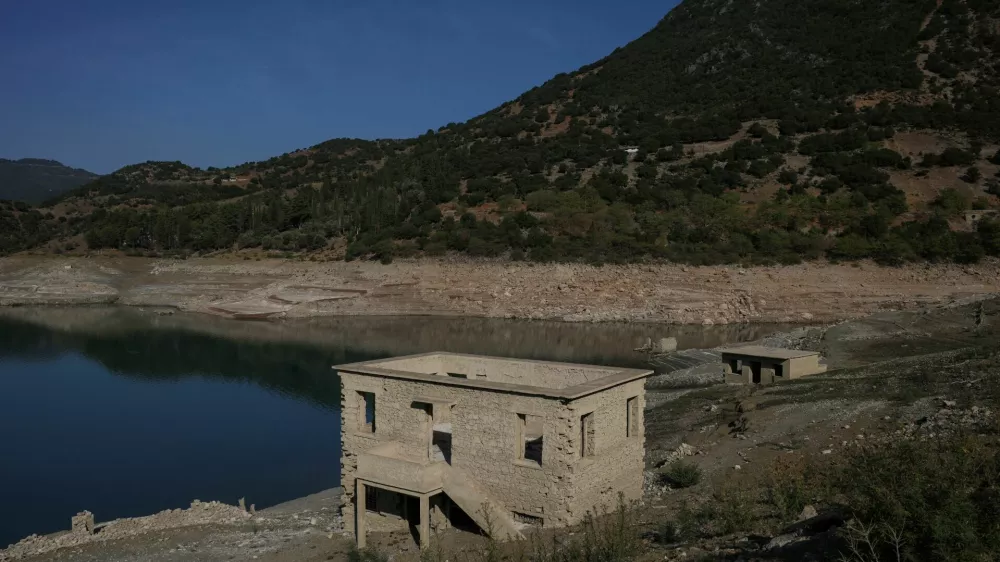 The reappearing remains of buildings of the village of Kallio, which was intentionally flooded in 1980 to create a reservoir that would help meet the water needs of Greek capital Athens, are seen following receding water levels caused by drought, in Lake Mornos, Greece, September 3, 2024. REUTERS/Stelios Misinas