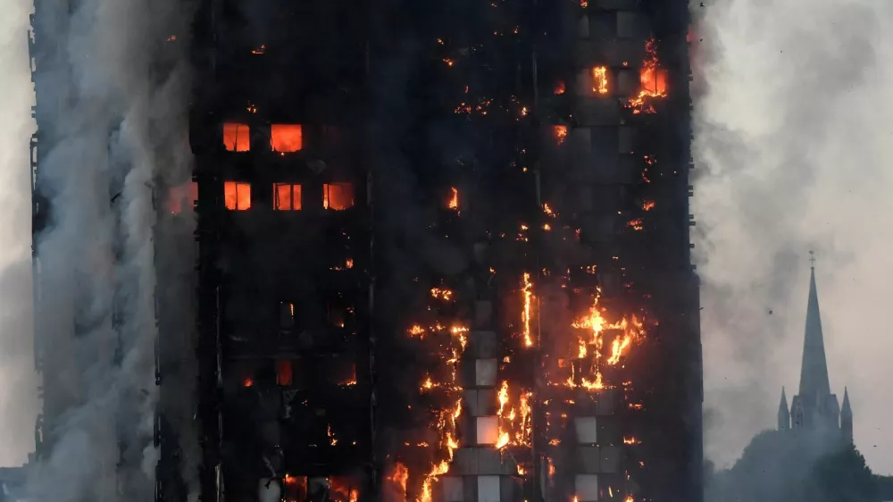 FILE PHOTO: The Grenfell Tower residential building is seen on fire in London, Britain, June 14, 2017. REUTERS/Toby Melville/File Photo