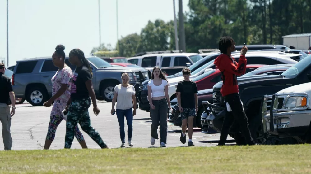 People walk near the scene of a shooting at Apalachee High School in Winder, Georgia, U.S. September 4, 2024. REUTERS/Elijah Nouvelage