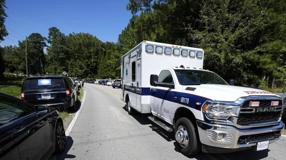 An ambulance departs Apalachee High School, after a shooting at the school Wednesday, Sept. 4, 2024, in Winder, Ga. (AP Photo/Mike Stewart)