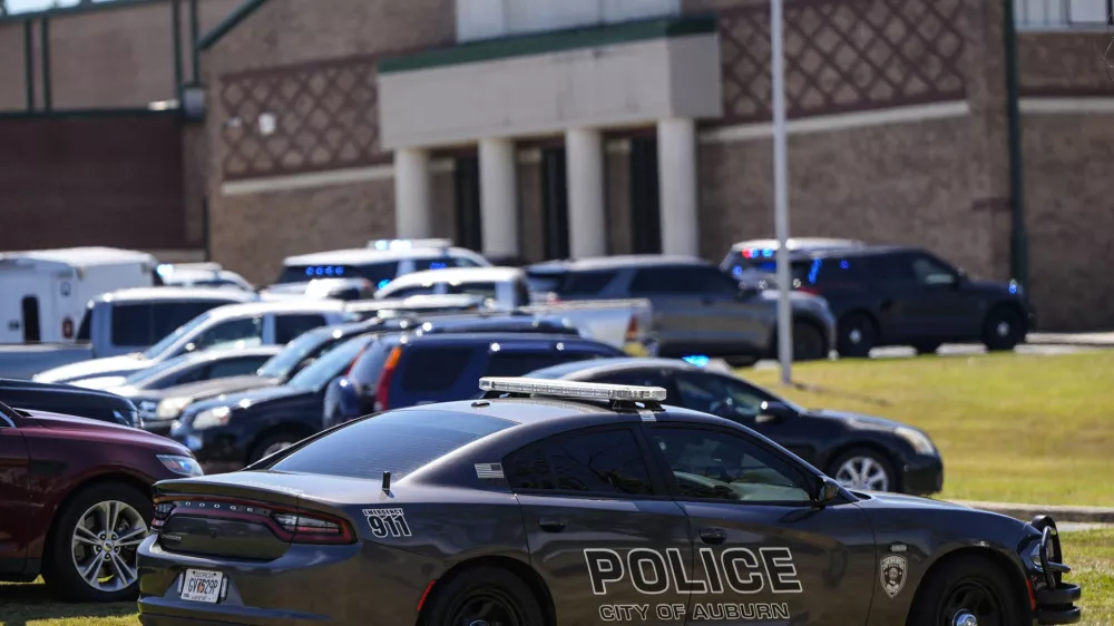 Police vehicles are seen outside Apalachee High School after a shooting there caused an unknown number of injuries and a suspect was arrested Wednesday, Sept. 4, 2024, in Winder, Ga. (AP Photo/Mike Stewart)