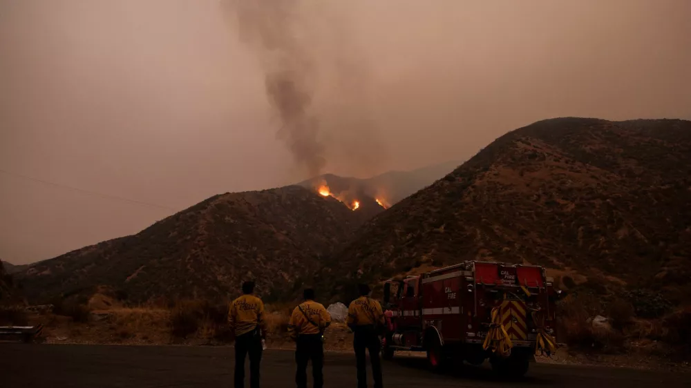 Firefighters monitor the progression of the Line Fire in the San Bernardino National Forest's mountains over Highland, California, U.S. September 8, 2024. REUTERS/Etienne Laurent