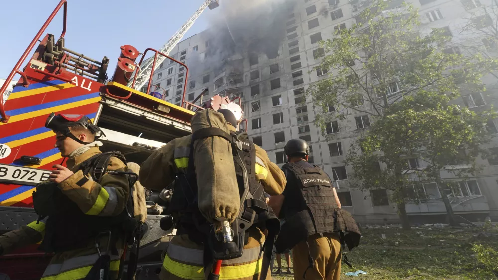 Firefighters tackle a blaze after a Russian aerial bomb struck a multi-story residential building in Kharkiv, Ukraine, Sunday Sept. 15, 2024. (AP Photo/Andrii Marienko)