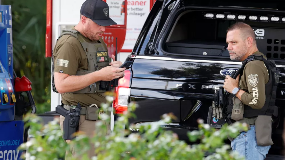Law enforcement officers stand after reports of shots fired outside Republican presidential nominee and former U.S. President Donald Trump's Trump International Golf Course in West Palm Beach, Florida, U.S. September 15, 2024. REUTERS/Marco Bello