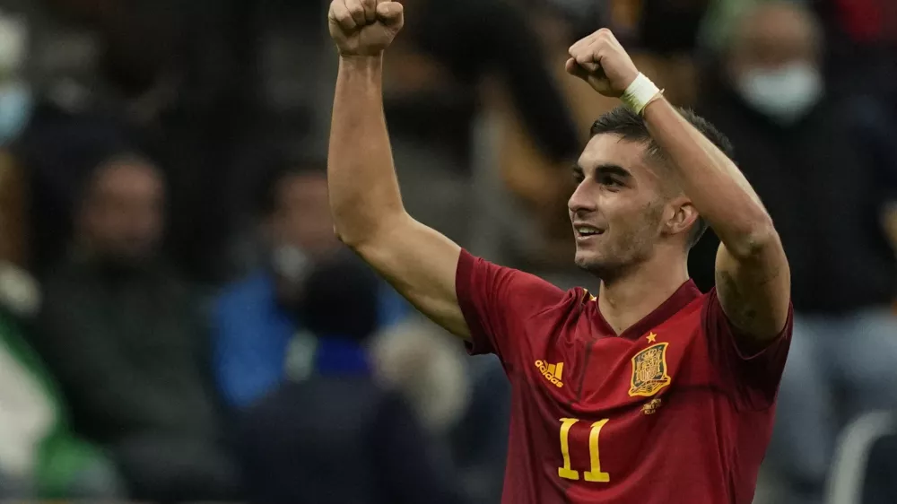 FILE - Spain's Ferran Torres celebrates after scoring during their Nations League semifinal soccer match against Italy at the San Siro stadium, in Milan, Italy, Oct. 6, 2021. Barcelona has completed the signing of Spain forward Ferran Torres from Manchester City, it was announced Tuesday, Dec. 28. Barcelona said Torres will have a buyout clause of 1 billion euros ($1.13 billion). (AP Photo/Antonio Calanni, file)