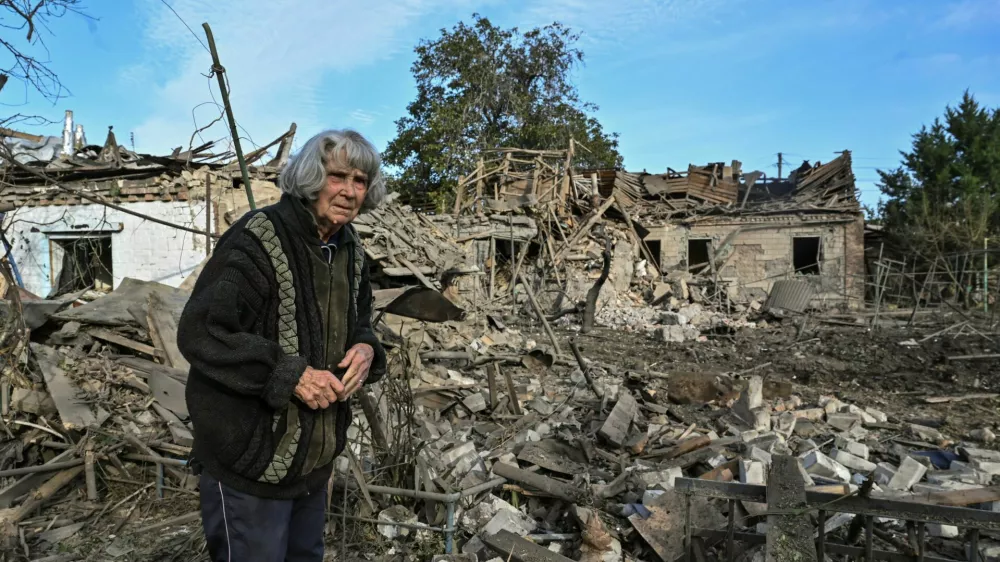 A woman stands in the backyard of her house destroyed by a Russian air strike, amid Russia's attack on Ukraine, in Zaporizhzhia, Ukraine October 10, 2024. REUTERS/Stringer